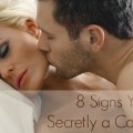 Man kissing on woman's cheek in bedroom